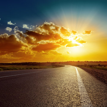 Orange Sunset Over Asphalt Road