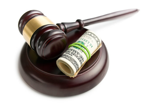 judge gavel with pack of dollars