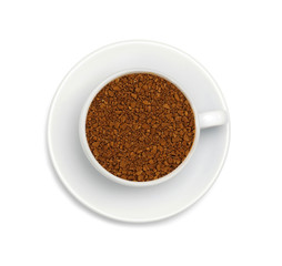 granules of instant coffee in a white cup and saucer isolated on