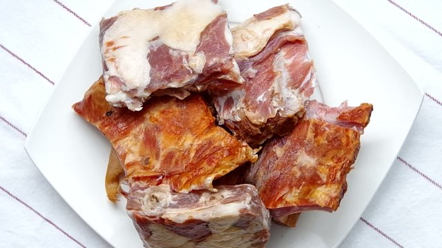 Raw meat ribs are spinning on the table