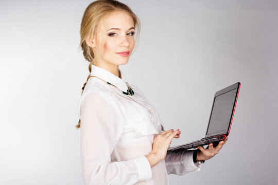 Portrait of  woman with a laptop over white background