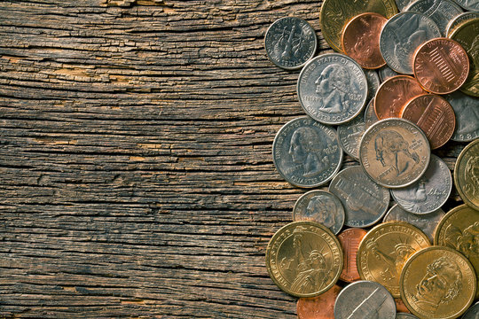 U.S. coins on old wooden background