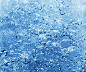 Clean water with bubbles appearing when pouring water