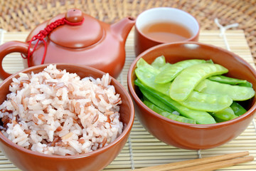 Stir fried Green Peas with Sesame Oil, Stemmed Jasmine Brown Rice and Chinese Red Tea, Common Homemade of Chinese Breakfast.
