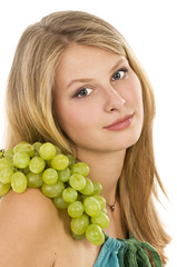 Long-haired beautiful blonde with grapes .