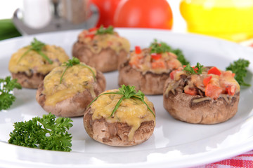 Stuffed mushrooms on plate on table close-up