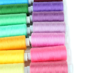 Colored spools of threads close up