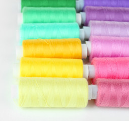 Fototapeta na wymiar Colored spools of threads close up