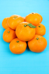 Ripe sweet tangerines, on color background