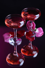 Composition with pink  wine in glasses and  rose petals