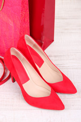 Beautiful red female shoes, belt and shop bags