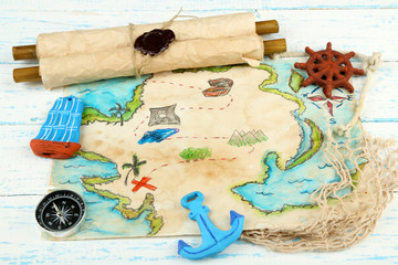 Treasure map with sea accessories, on wooden background