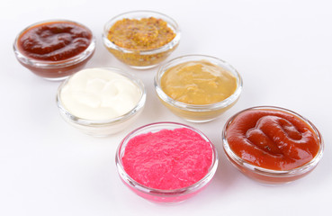 Various sauces isolated on white