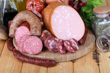 Different sausages on wooden table close-up