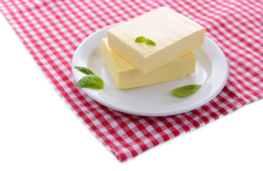 Tasty butter on plate, isolated on white