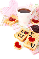Delicious toast with jam and cup of tea on table close-up