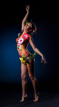 Mysterious girl with flowers and patterns on body