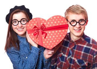 Teen couple with heart shape gift.