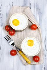 Baked eggs on table close up