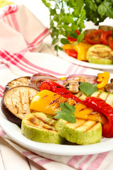 Delicious grilled vegetables on plate on table close-up