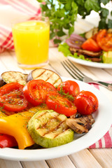Delicious grilled vegetables on plate on table close-up