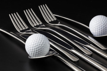 Forks,spoons and knifes and golf balls