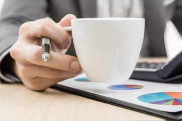 Businessman's hand showing financial report