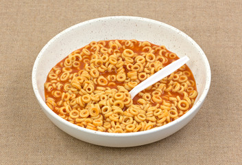 Round spaghetti in sauce with spoon