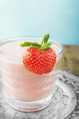 Strawberry milk shake in silver plate mit berry on glass