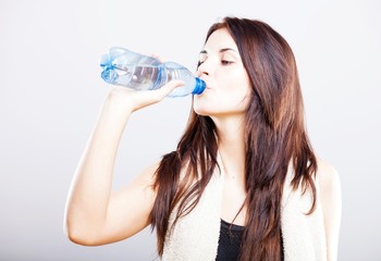 Young fit woman drinking water after fitness - Powered by Adobe