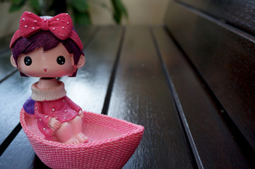 Doll on wooden chair