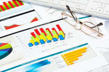 Obraz premium glasses, business papers with charts