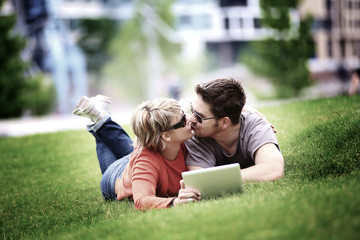 Couple using laptop in city park (lomo efect)