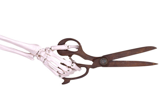 skeleton hand with old scissors