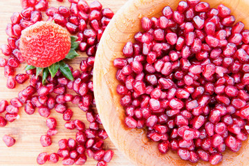 Pomegranate seeds with a strawberry
