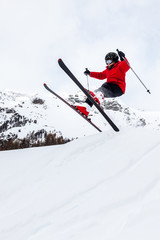 Little skier jumping in the snow.