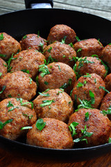 Fried pork meatballs in frying pan