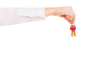 Female hand real estate agent holding set of keys to new house