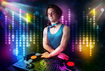 Dj playing songs in a disco with light show