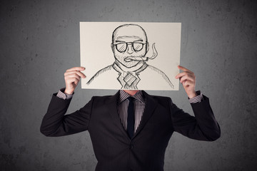 Businessman holding a cardboard with a smoking man on it in fron