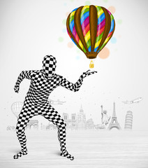 man in full body suit holding balloon