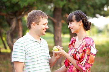 Happy middle aged couple with apple.