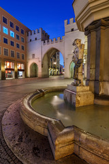 Brunnenbuberl Fountain and Karlstor Gate in the Evening, Munich,