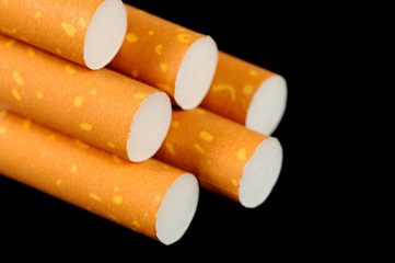 Cigarettes with Yellow Filters on Black Background