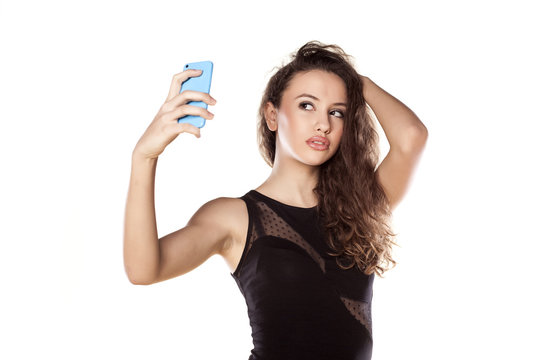 pretty teen girl taking selfies with her smart phone