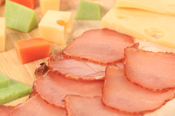Close up of varoius cheese and tomatoes.