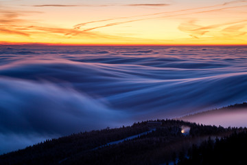 Inversion above the ski resort with lift and snow cannon