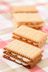 Fototapeta na wymiar Sandwich cookies on pink tablecloth