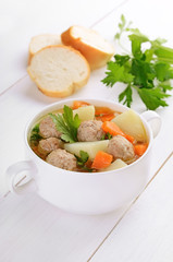 Meatball soup in a white bowl