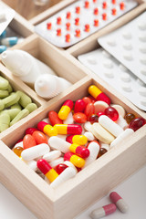 medical pills and ampules in wooden box